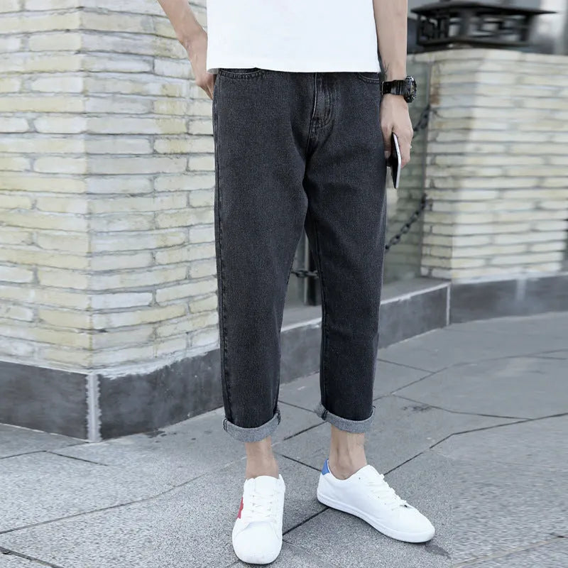 Men's black straight-leg jeans with loose fit and light straight leg opening on hanger
