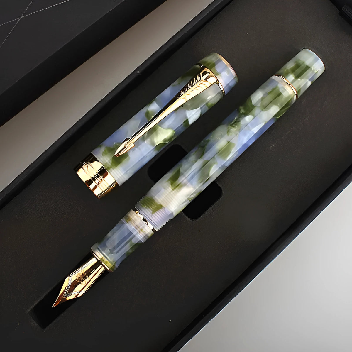 Deep bath green metal ballpoint pen with three removable tips: fine, medium, and graphic.