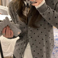 Women's grey dot knitted cardigan with crocheted flower details on sleeves, loose fit.