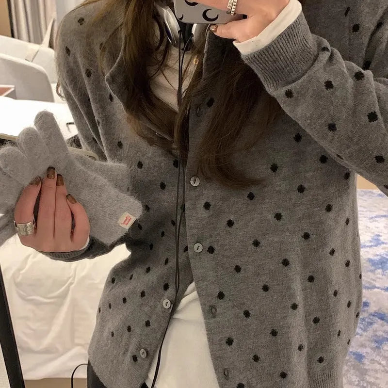 Women's grey dot knitted cardigan with crocheted flower details on sleeves, loose fit.