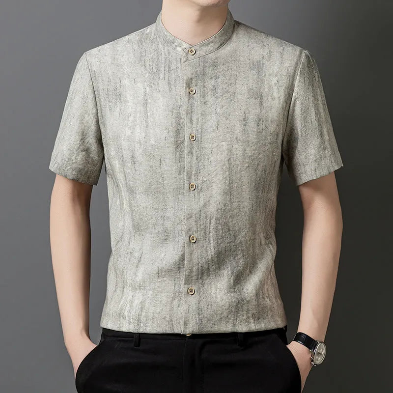 Man wearing a loose-fit black grey linen cardigan-style shirt with a stand collar and short sleeves.