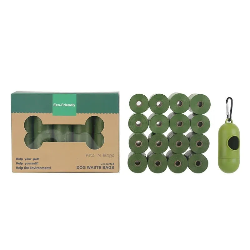 Roll of EPI degradable green dog poo bags next to a time-capsule-style dispenser on a grass background.