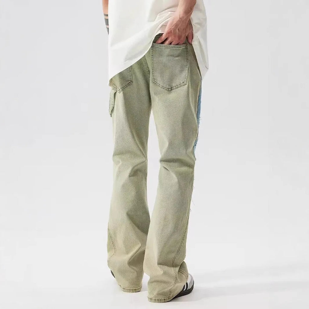 Retro yellow and blue dual-colour patchwork splash-ink damaged design jeans with mid waist and zip fly.