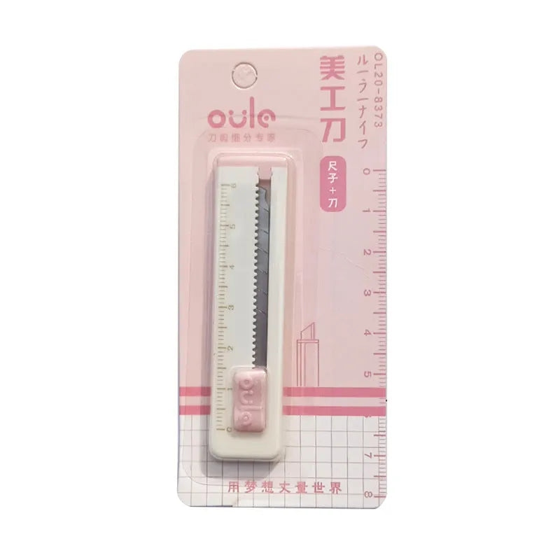 Small plastic art knife in one of five colours: pink, blue, purple, khaki, or orange.