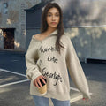 Woman wearing a light khaki alpaca wool pullover sweater with an oblique zipper and retro turtleneck.