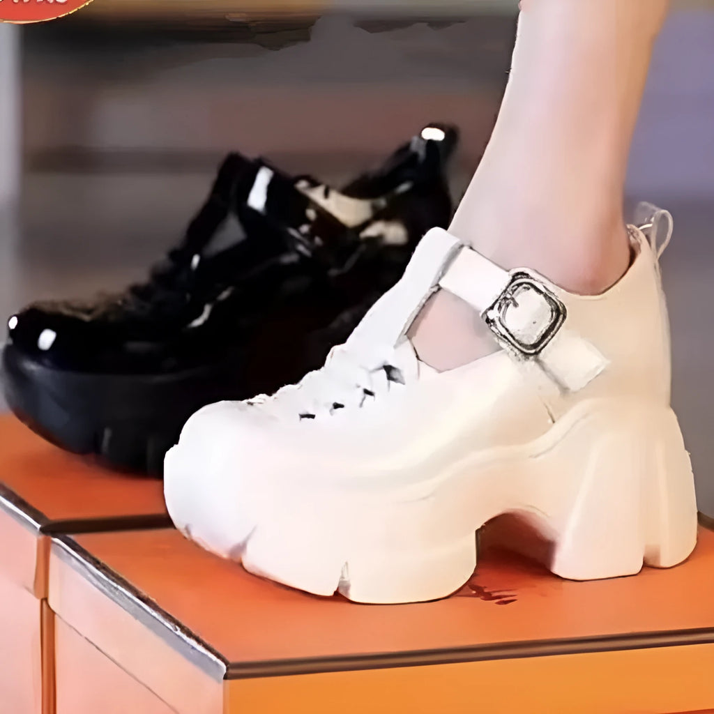 Women's black and creamy white platform pumps with chunky wedge heel and skull pattern detail.