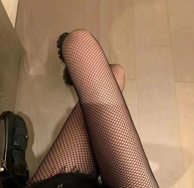 Women's mesh stockings showing large, medium and small patterns in black and white colours