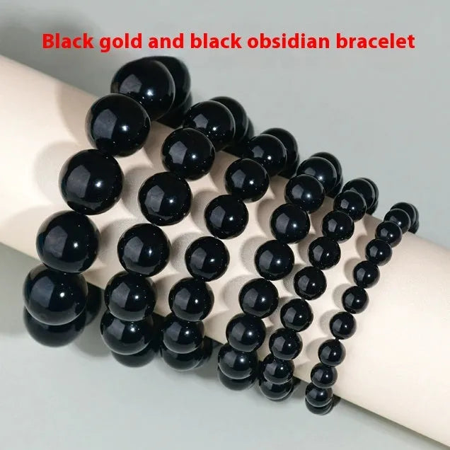 Adjustable sliding knot obsidian bracelet in hand with choice of black, rainbow eye, and silver crystal beads
