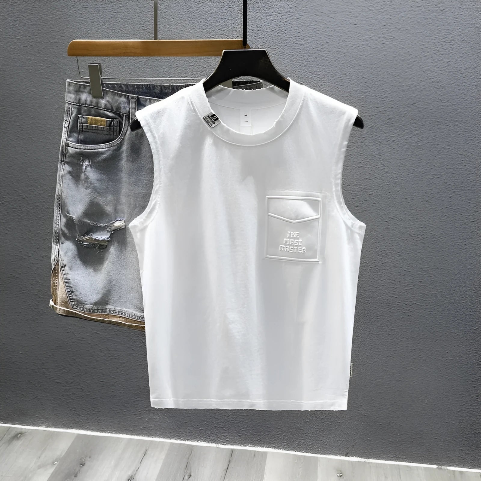 Man wearing a loose-fit black cotton sleeveless t-shirt or muscle tank.