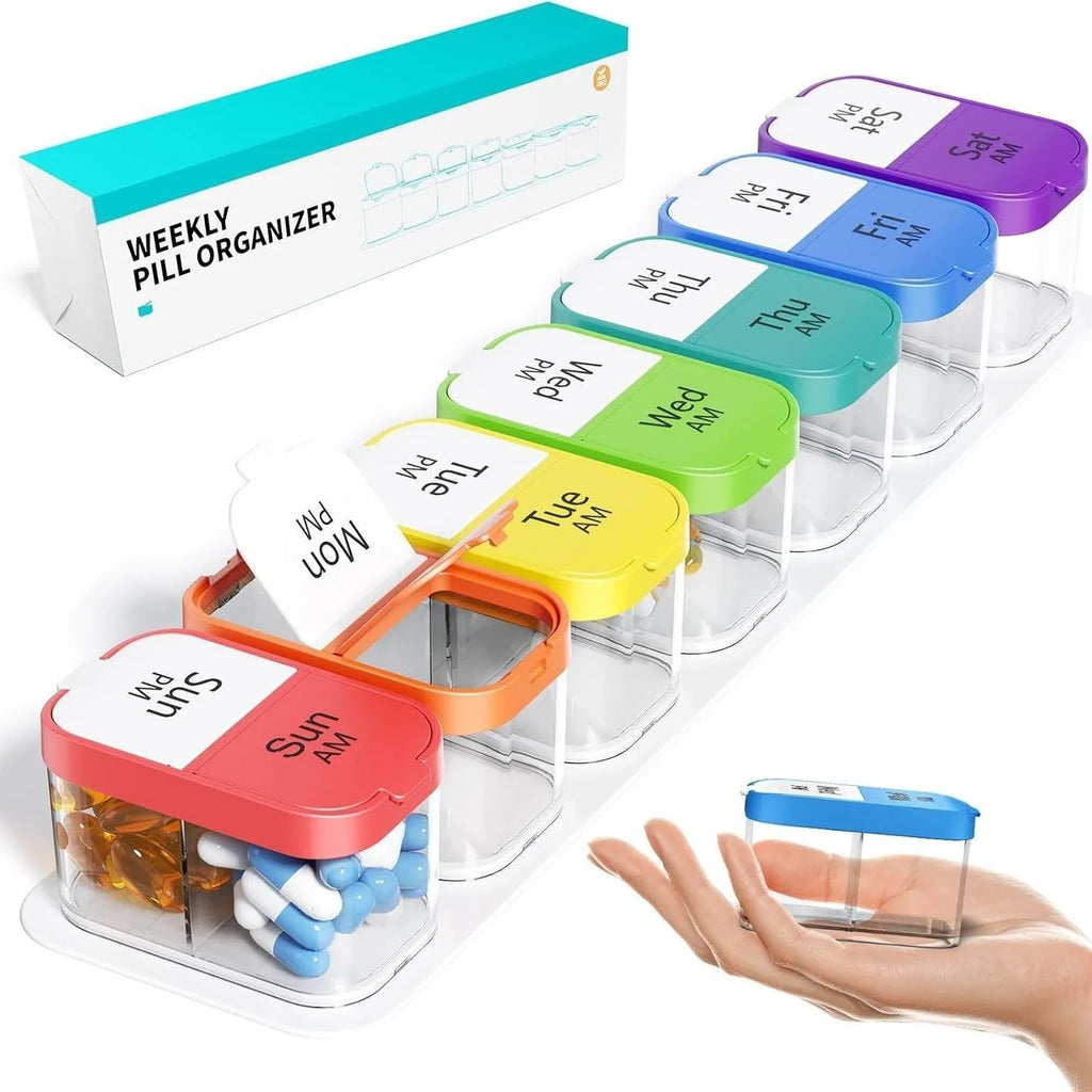 Extra large white plastic pill dispenser with 14 removable rainbow-coloured grid compartments open on a table.