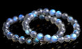 Natural blue moonlight crystal bracelet with smooth beads on a plain background.