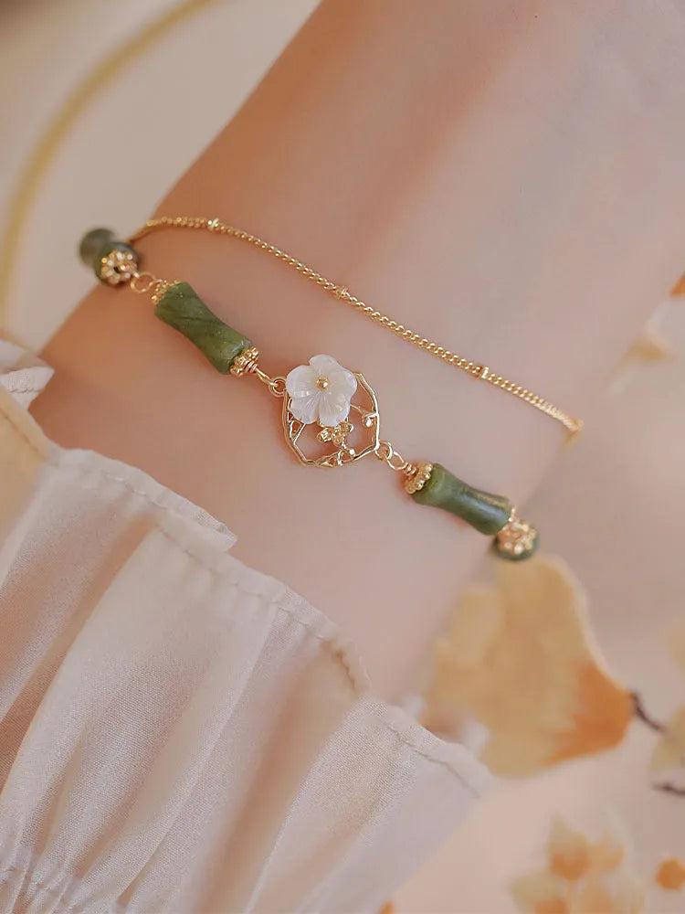 Handcrafted green olivine bracelet with double layer twin bells and olive branch design.