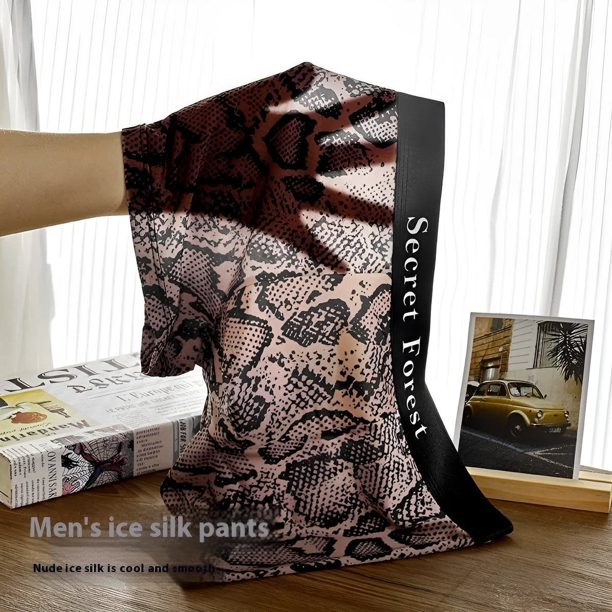 Men's thin loose polyester boxer shorts in black, grey, and brown colours on a mid-waist model.
