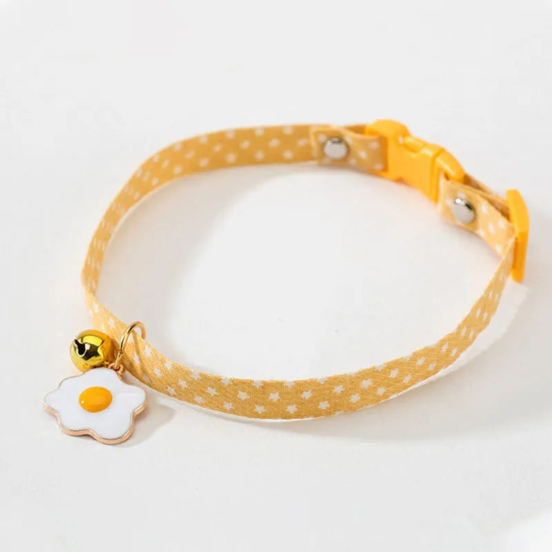 Green adjustable cat collar with metal bell pendant and matching bow tie accessory for small pets