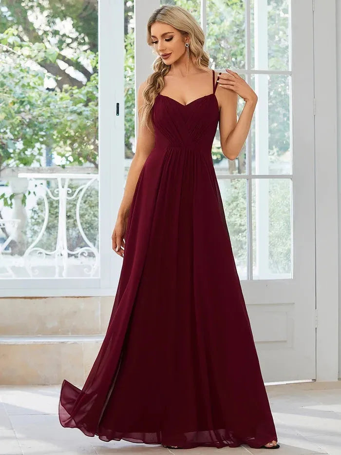 Women's long sling banquet dress with pleating detail in A-line silhouette, available in multiple colours