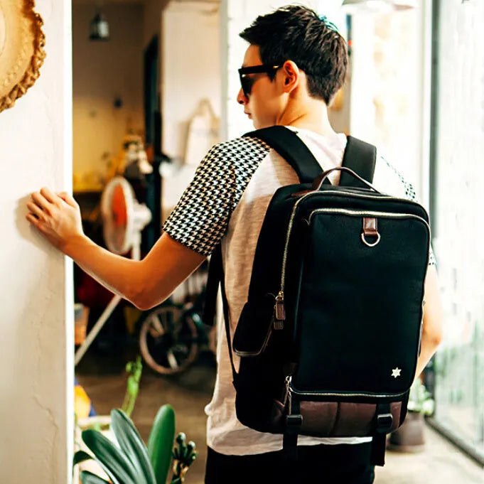 Modern army green Oxford cloth men's backpack showing large main compartment and adjustable straps.