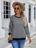 Black plaid print pullover sweater with long sleeves on mannequin