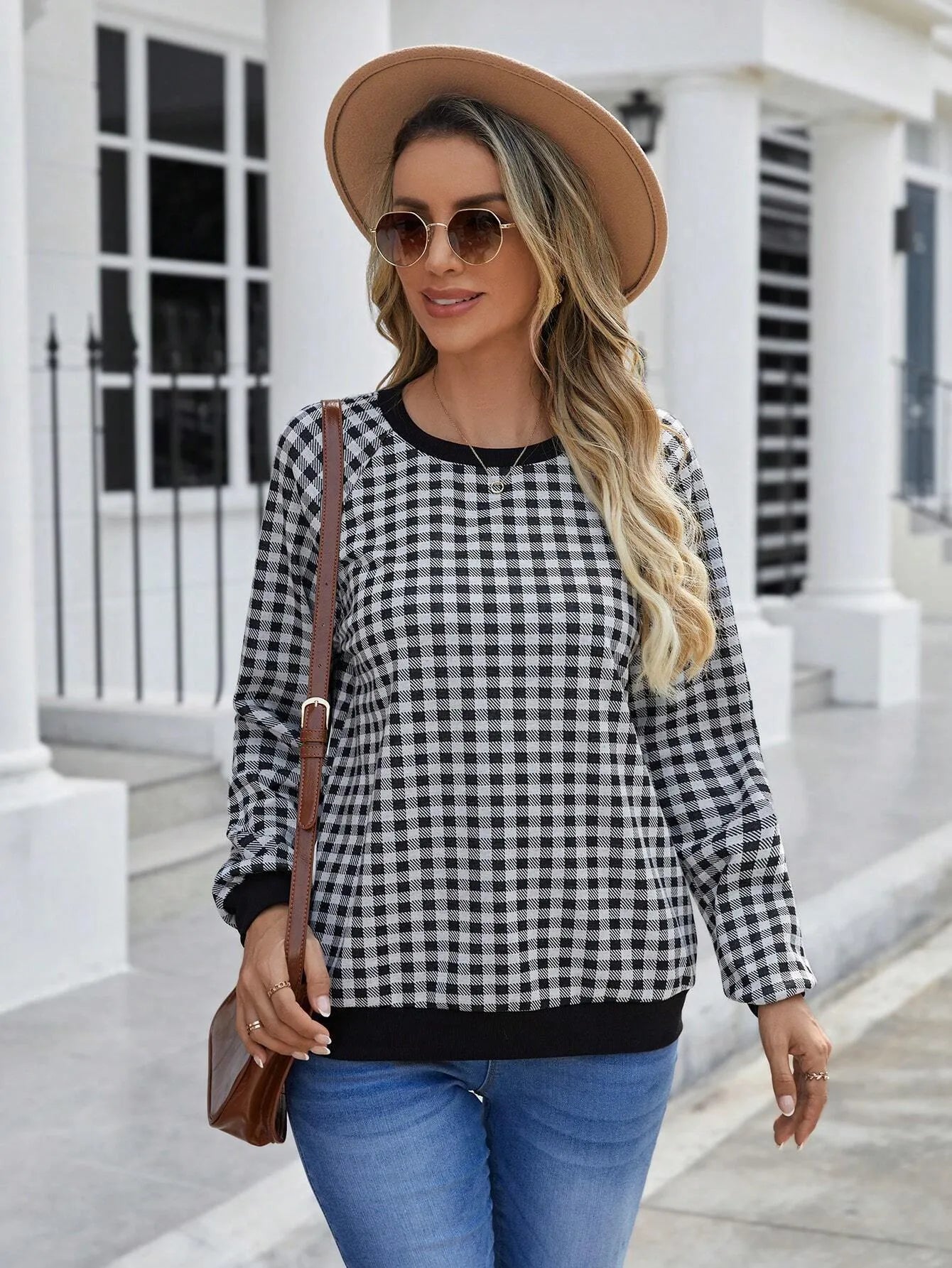 Black plaid print pullover sweater with long sleeves on mannequin