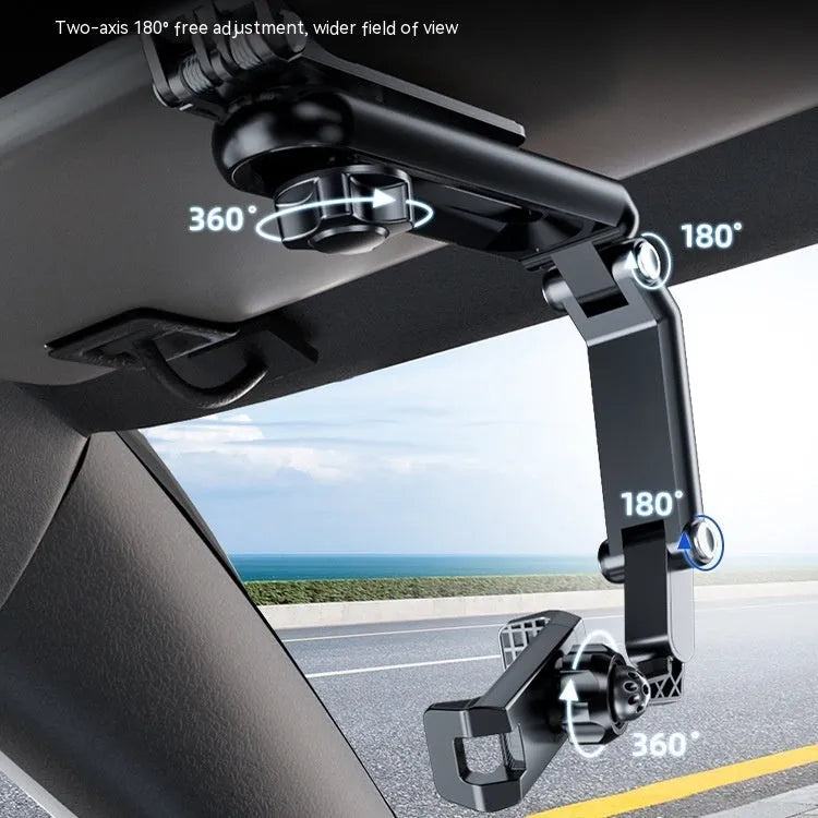 Grey single-clip car phone holder mounted on a car dashboard holding a mobile phone.