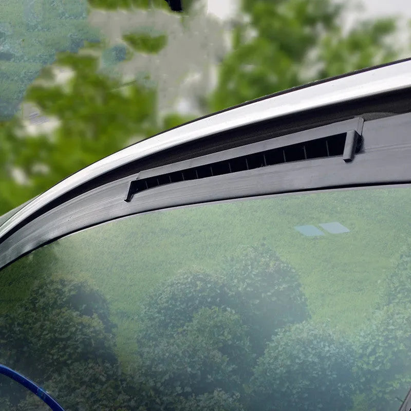 Black and white USB-powered car ventilation fan on a car dashboard