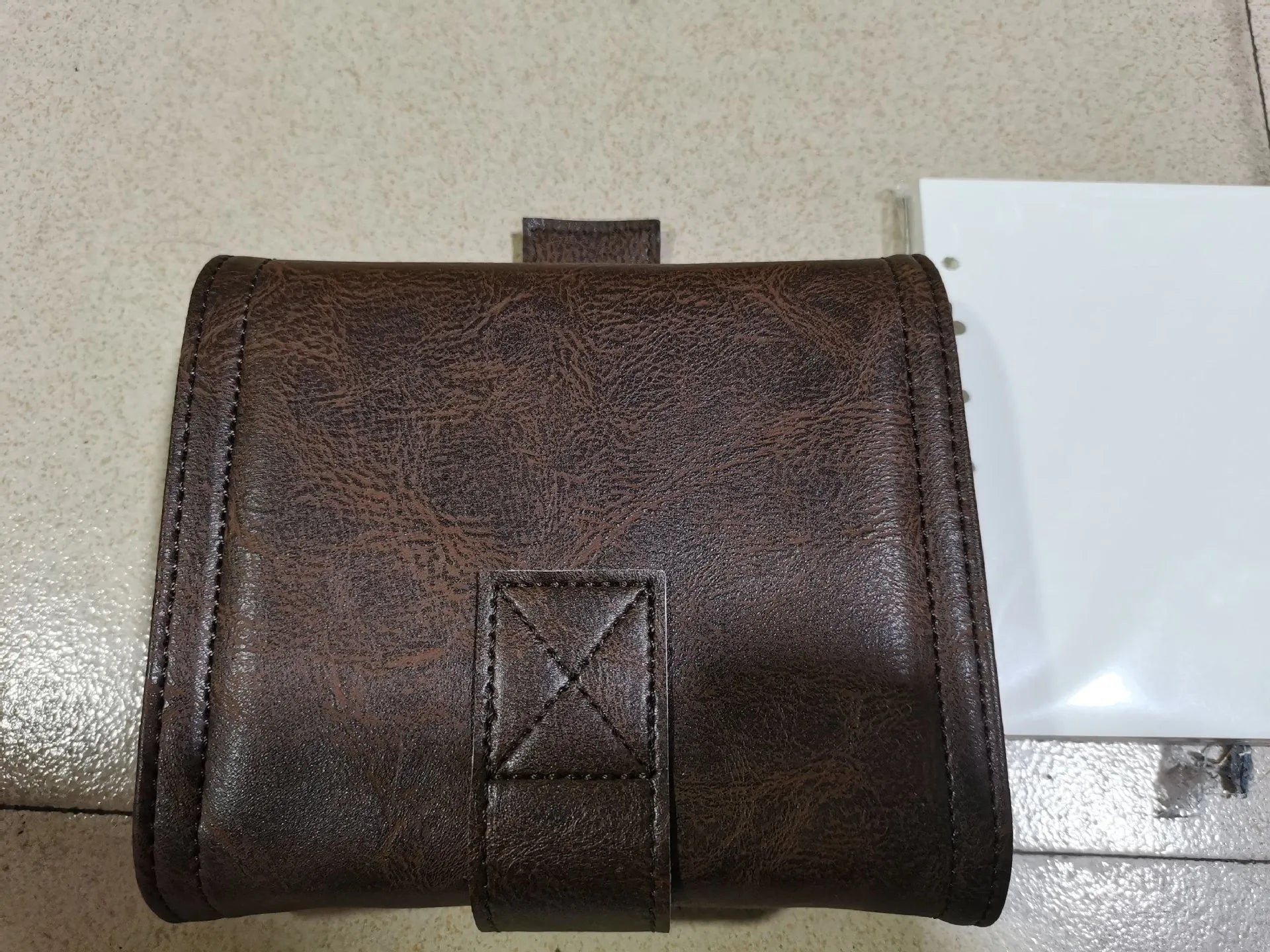 Brown retro leather-look PU cover A7 notebook with loose-leaf binder binding open on a desk.
