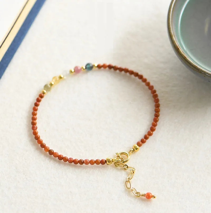 Women's freshwater pearl bracelet with crystal accents and geometric charms on elastic rope