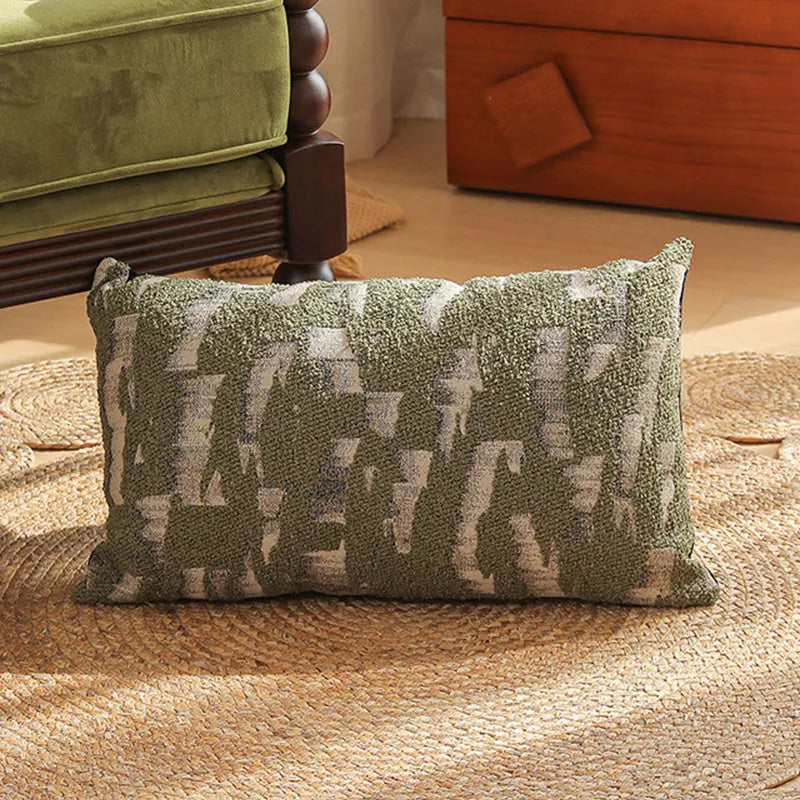 Square jacquard pillow cover with botanical pattern on a sofa, showing one of eight available colour options.