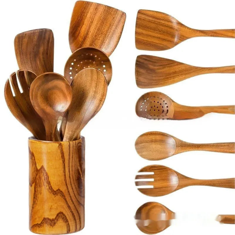 A set of seven wooden kitchen utensils including various spoons and spatulas on a table.