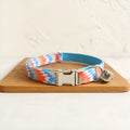 Blue polyester cat collar with printed pattern and lock closure, shown in sizes S and L