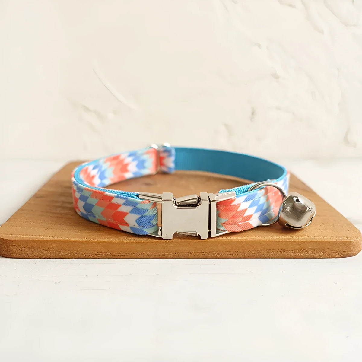 Blue polyester cat collar with printed pattern and lock closure, shown in sizes S and L