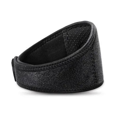 Black self-heating magnetic therapy neck guard with an adjustable shoulder strap laid flat.
