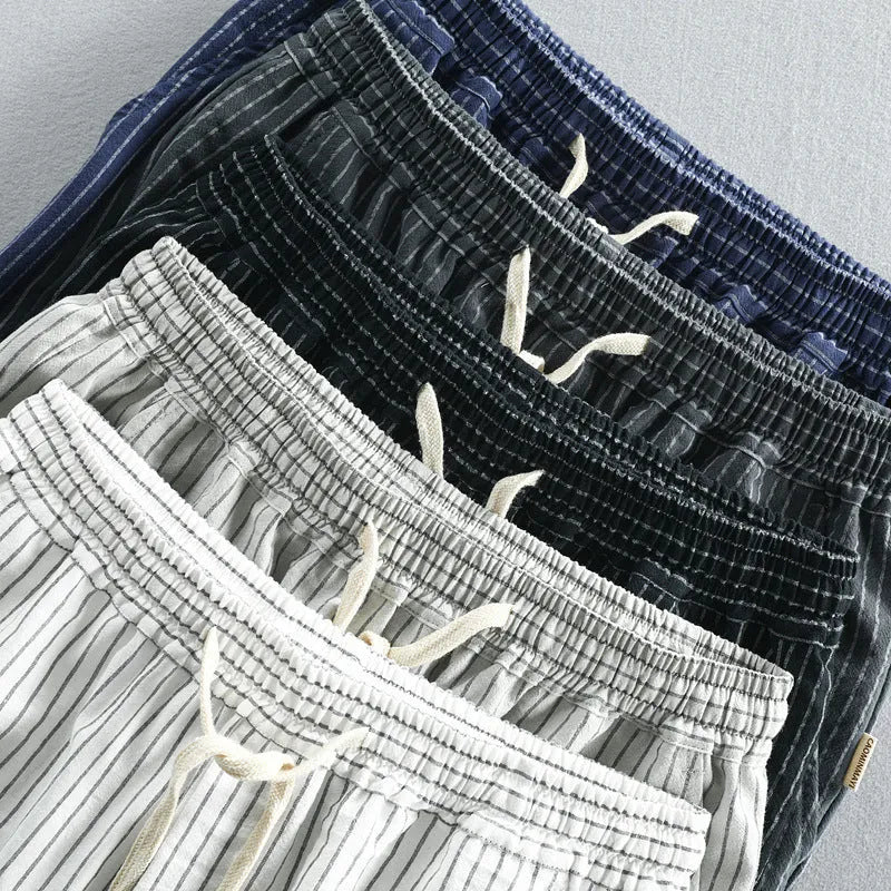 Men's striped cotton shorts in multiple colours showing loose straight cut and mid-waist design