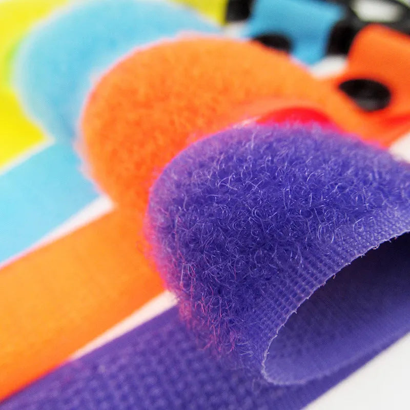 Nylon luggage velcro hook in assorted colours on a white background, showing the looped design and individual OPP pack.