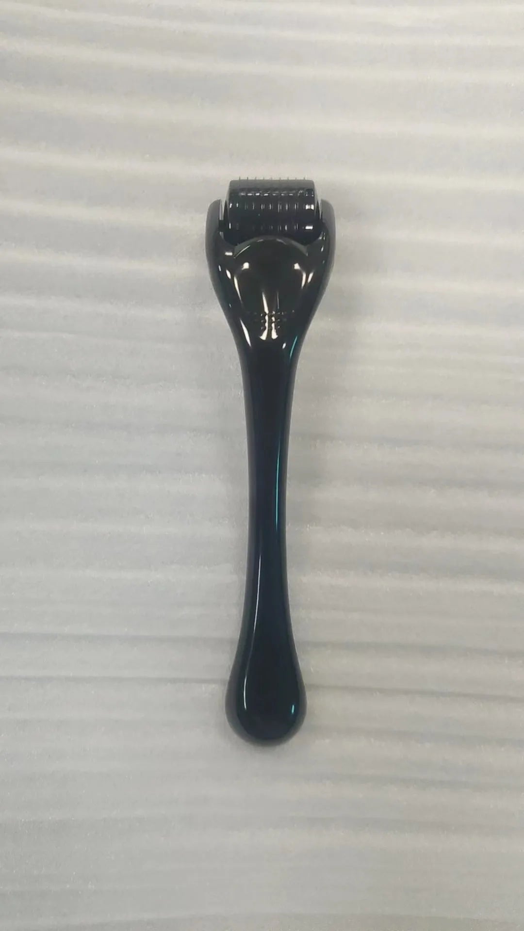Sterile 540 micro needle derma roller showing handle and needle wheel in assorted colours.