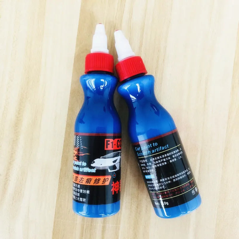 Blue car scratch repair cream bottle with applicator tool for automotive paint damage