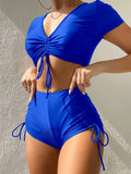 Women's two-piece swimsuit with lace-up front top and matching shorts in polyester material.