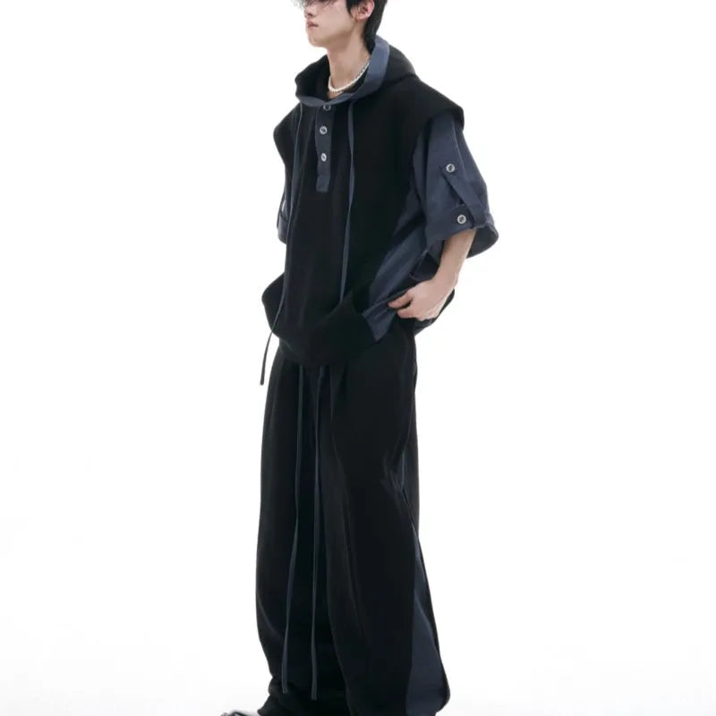 Men's black heavy industry sports suit with hooded short sleeve jacket and trousers laid flat.