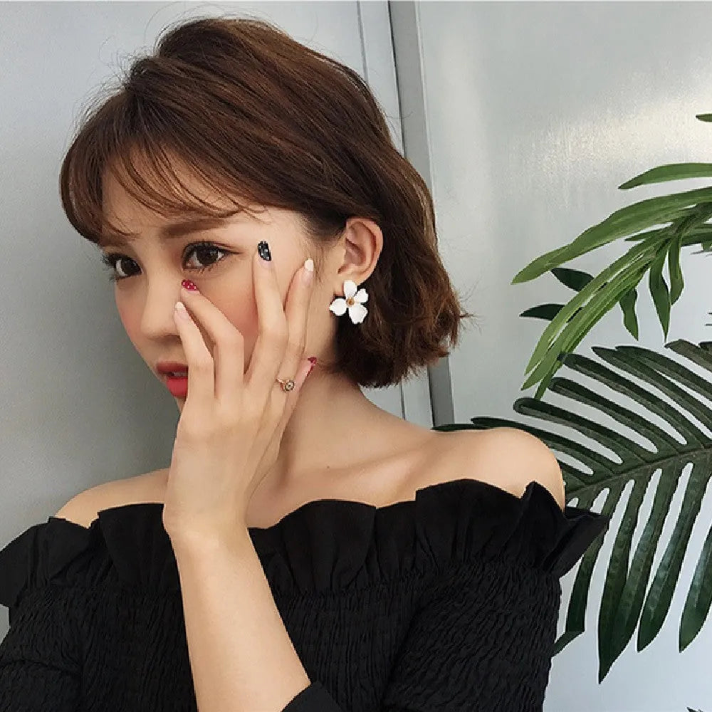 Flower shaped stud earrings in pink and white colours with electroplated alloy finish