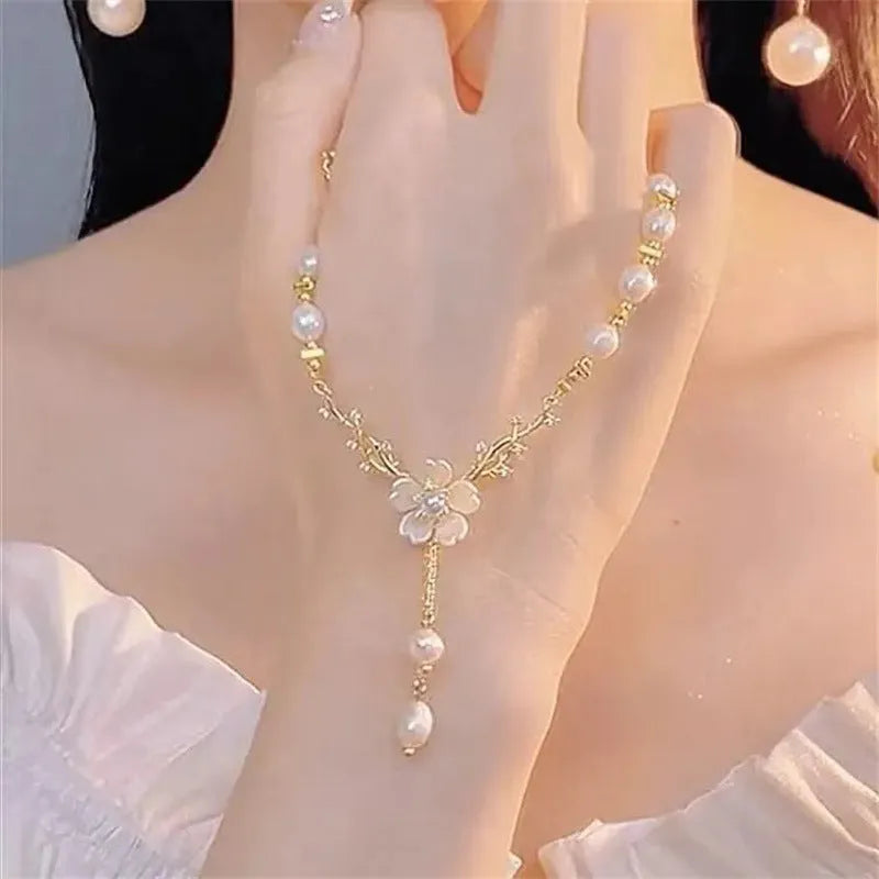 Alloy fashion necklace with pearl flower design and rose floral elements on pearl chain