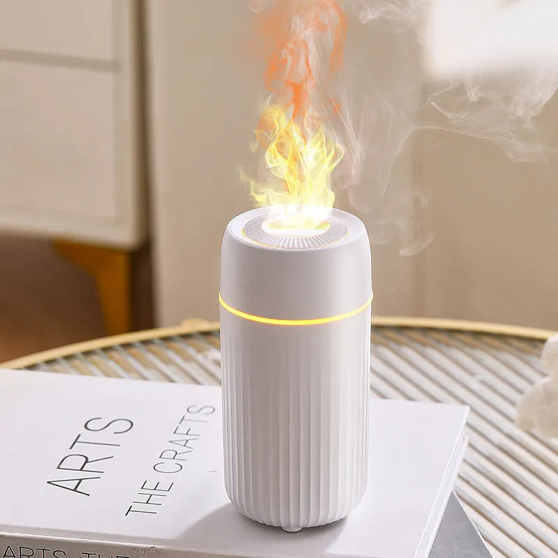 Black and white car aroma diffuser with simulation flame effect on a car console.
