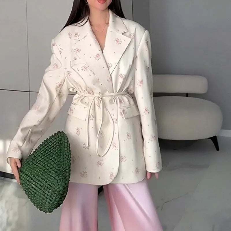 Women's suit jacket with lace-up detail at the collar and waist, shown in a floral print colour option.