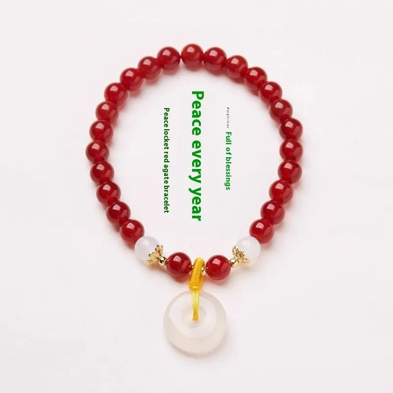Handmade natural jinsi jade and red agate peace clasp bracelet with safety buckle on wrist.