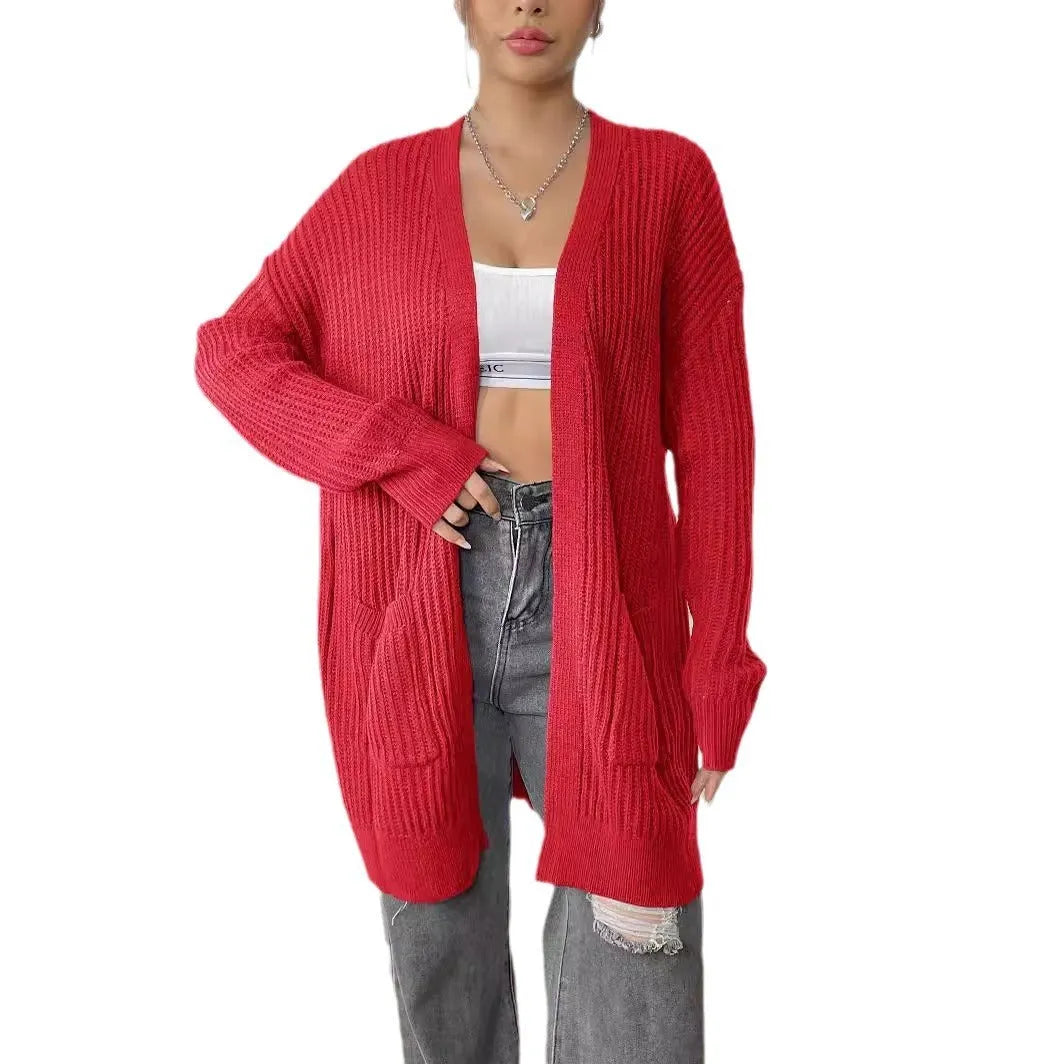 Women's dark green loose-fit mid-length acrylic cardigan sweater on a hanger.