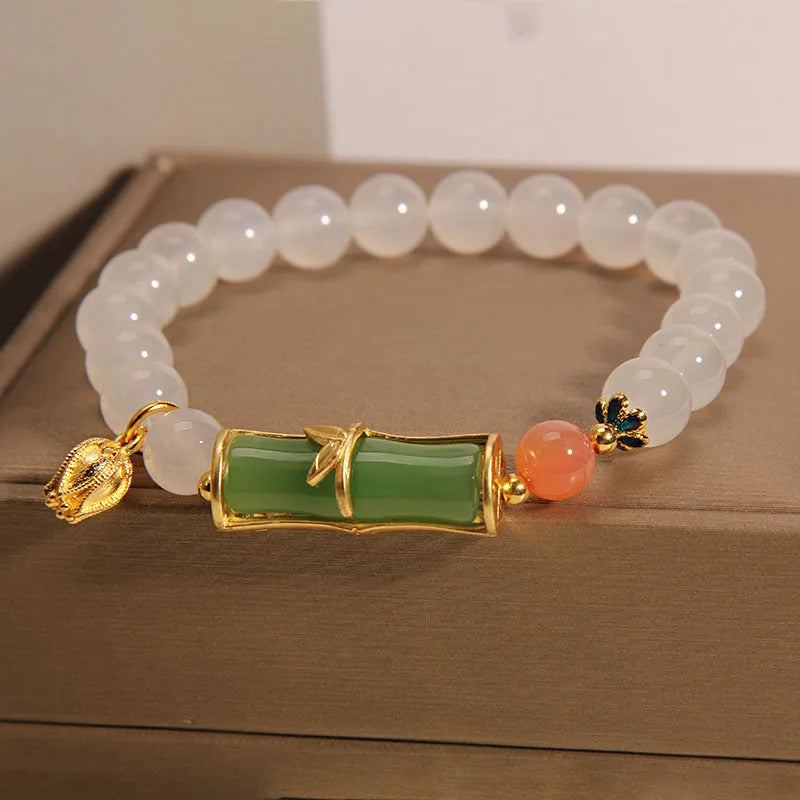 Women's Chinese style beaded bracelet with white agate centre, jade beads, and bamboo joint design.