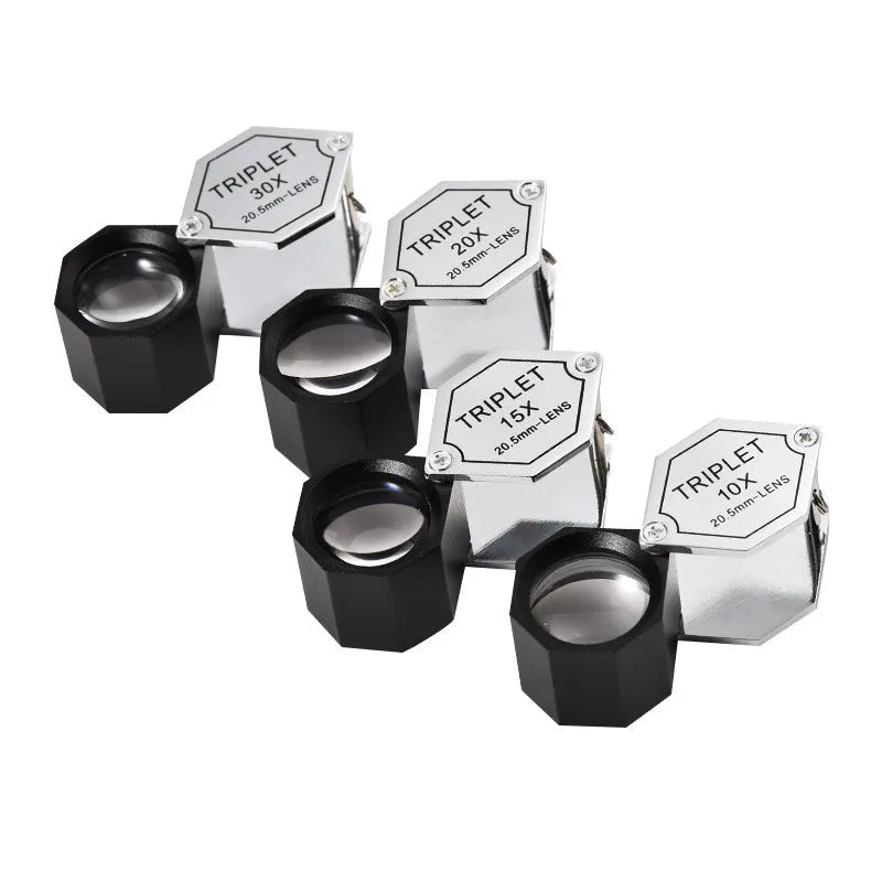 Handheld portable magnifying glass with metal body and optical glass lens for jewellery and coin inspection.