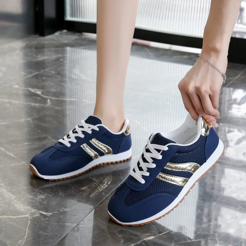 Blue women's casual tennis shoes with a cross strap and white non-slip rubber sole.