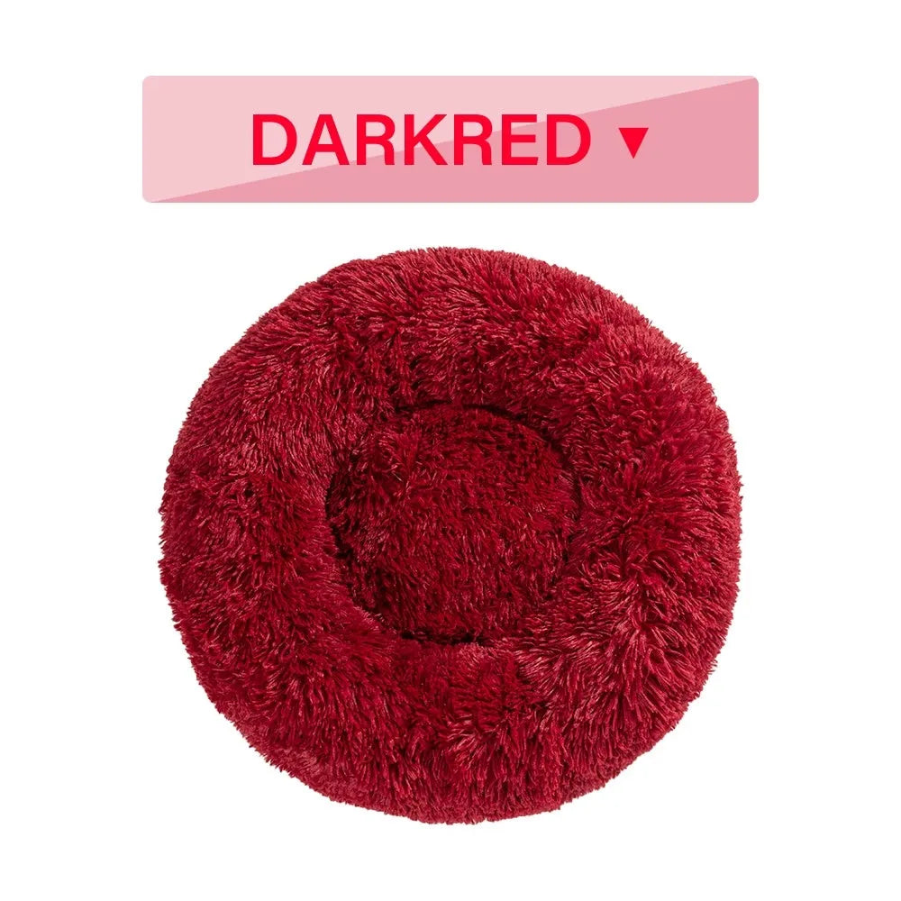 Fluffy donut-shaped dog bed in long plush fabric, showing raised rim and available colour options