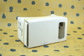 Pink and white cardboard VR glasses for smartphones with 3D lenses and adjustable headband