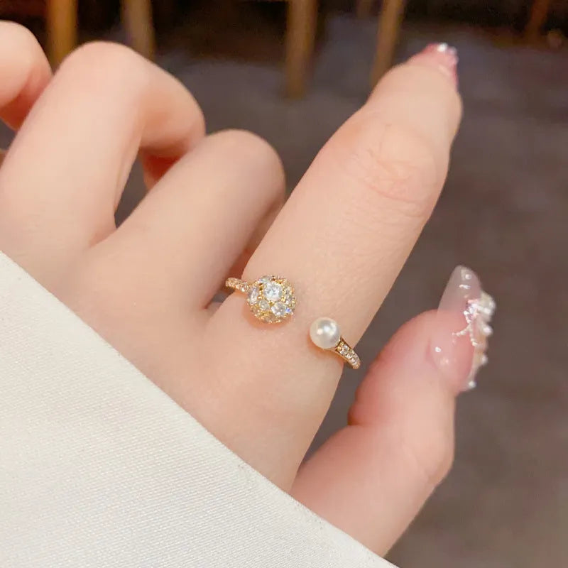 Adjustable open-end pearl ring with round zircon elements in gold plating