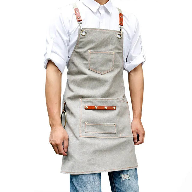 Cross-back canvas apron in camel colour with adjustable straps for café and baking work